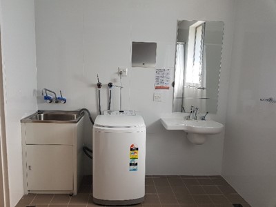 Accessible laundry in Lifestyle Solutions Supported Independent Living property in Albion Park Rail, NSW