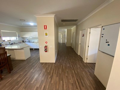 Accessible dining area and kitchen in Lifestyle Solutions four-bedroom Supported Independent Living (SIL) house in Silkstone, Qld